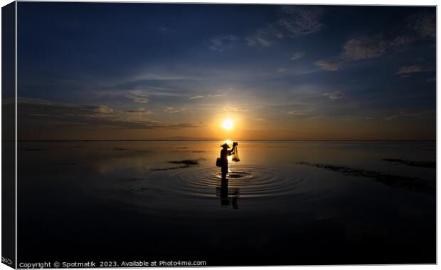 Silhouette Balinese male fishing Indonesian coastline at sunrise Canvas Print by Spotmatik 