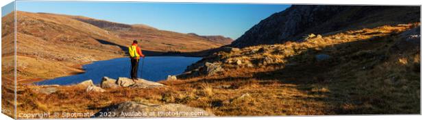 Panoramic lake Snowdonia National Park with female hiker Canvas Print by Spotmatik 