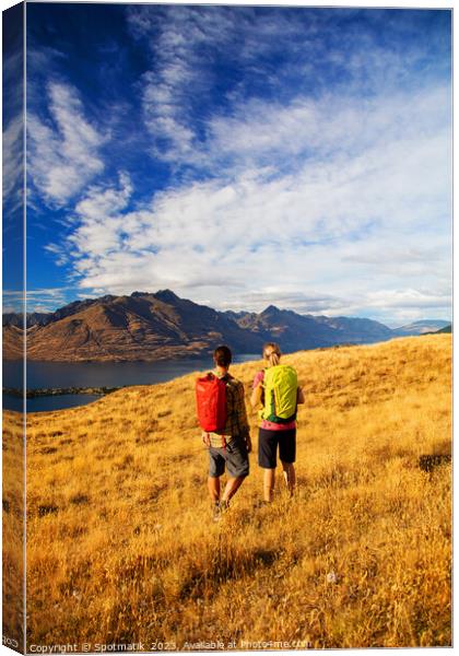 New Zealand trekking couple viewing Lake Wakatipu Otago Canvas Print by Spotmatik 