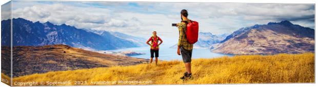 Panorama of male taking smartphone travel photos of girlfriend Canvas Print by Spotmatik 