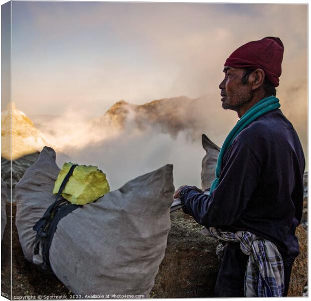 Sulphur blocks carried by poor manual Indonesian worker Canvas Print by Spotmatik 