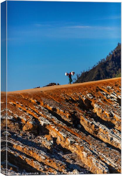 Indonesian male worker carrying sulphur blocks volcano Rim  Canvas Print by Spotmatik 