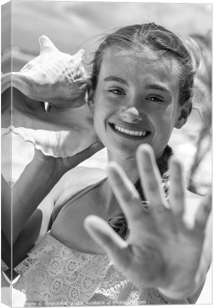 Portrait of young female listening seashell on beach Canvas Print by Spotmatik 