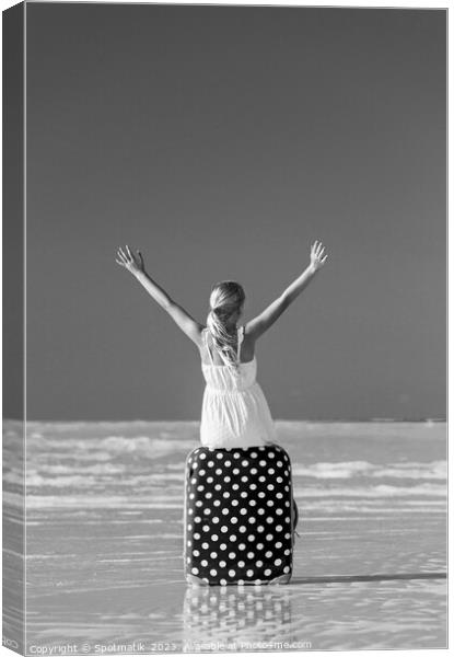 Blonde female teenager on beach sitting on suitcase Canvas Print by Spotmatik 