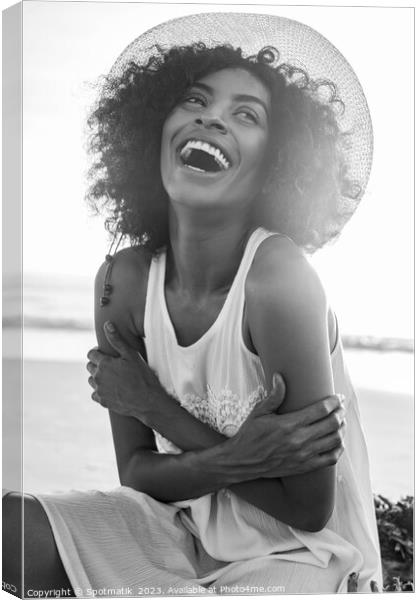 Laughing Afro American female wearing hat on beach Canvas Print by Spotmatik 