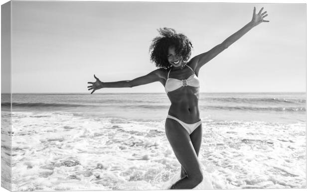 African American girl enjoying Summer fun in ocean Canvas Print by Spotmatik 