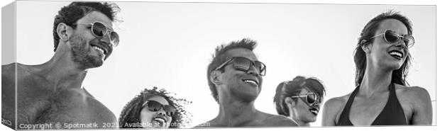 Panoramic view of smiling young friends in sunglasses Canvas Print by Spotmatik 
