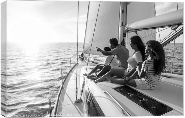 Relaxed family on luxury yacht sailing towards sunset Canvas Print by Spotmatik 