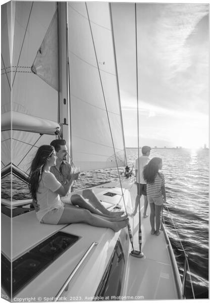 Hispanic family enjoying vacation on yacht at sunset Canvas Print by Spotmatik 