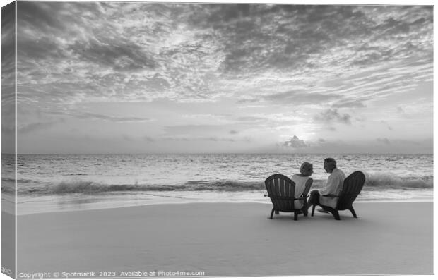 Mature couple enjoying ocean sunset on beach Bahamas Canvas Print by Spotmatik 