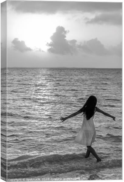 Asian female dancing in ocean waves at sunrise Canvas Print by Spotmatik 