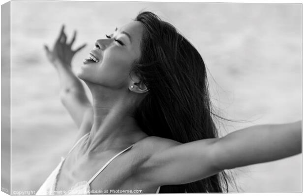 Asian girl enjoying freedom outdoors by the ocean Canvas Print by Spotmatik 