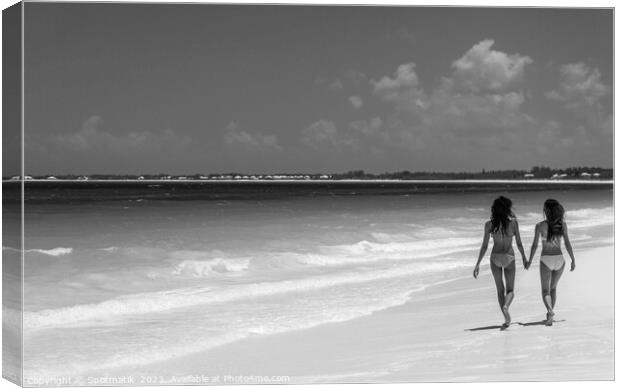 Tropical beach resort with girls walking by ocean Canvas Print by Spotmatik 