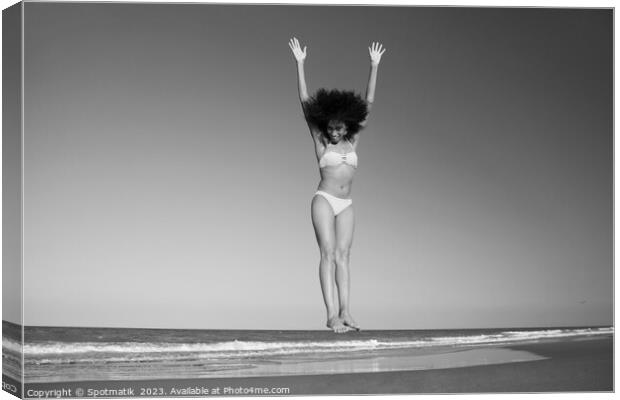 Afro American woman in swimwear jumping for joy Canvas Print by Spotmatik 