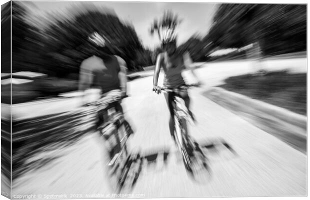 Afro American cyclists riding bikes in motion blur Canvas Print by Spotmatik 