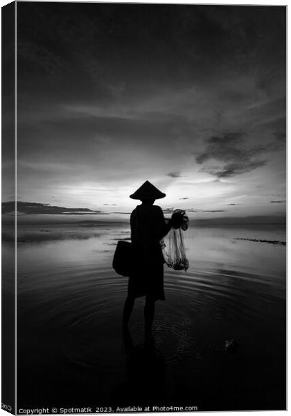Balinese male fishing at sunrise Flores sea coastline  Canvas Print by Spotmatik 