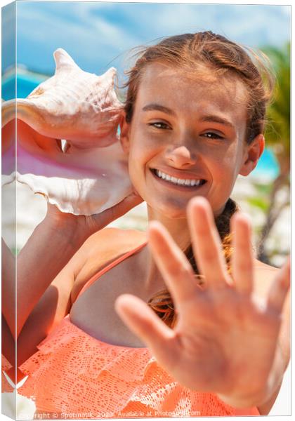 Portrait of young female listening seashell on beach Canvas Print by Spotmatik 