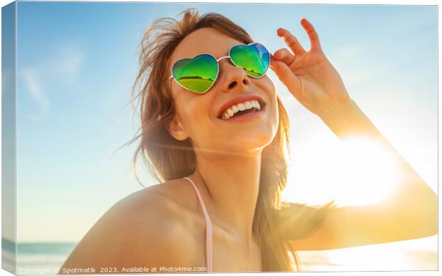 Caucasian girl wearing heart shaped sunglasses on beach Canvas Print by Spotmatik 