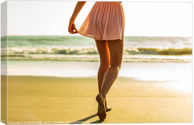 Young girl enjoying solo beach vacation at sunset Canvas Print by Spotmatik 