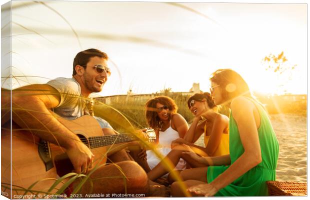 Young friends enjoying guitar music on beach vacation Canvas Print by Spotmatik 