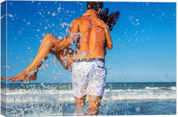Fun loving ethnic couple running in ocean waves Canvas Print by Spotmatik 