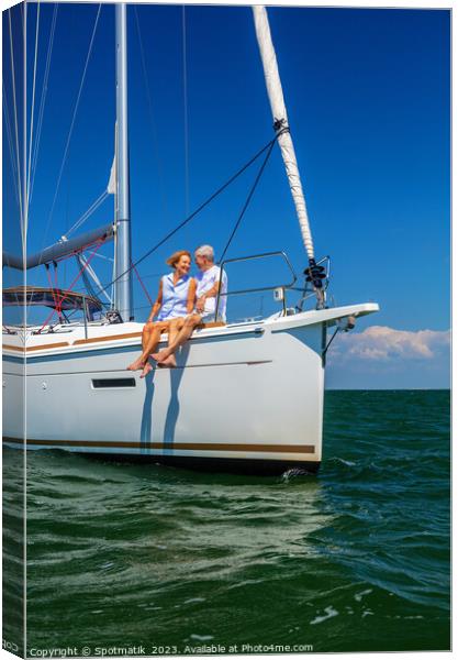 Loving retired couple relaxing together on luxury yacht Canvas Print by Spotmatik 