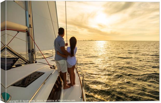 Hispanic couple travelling on luxury yacht at sunset Canvas Print by Spotmatik 