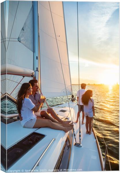 Hispanic family enjoying vacation on yacht at sunset Canvas Print by Spotmatik 
