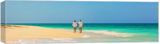 Panoramic view mature couple walking on beach Bahamas Canvas Print by Spotmatik 