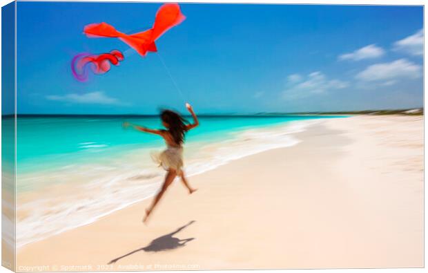 Motion blurred woman jumping on beach flying kite Canvas Print by Spotmatik 