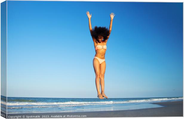 Afro American woman in swimwear jumping for joy Canvas Print by Spotmatik 