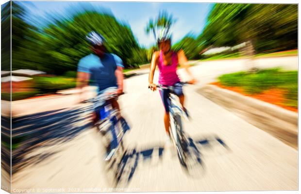 Afro American cyclists riding bikes in motion blur Canvas Print by Spotmatik 