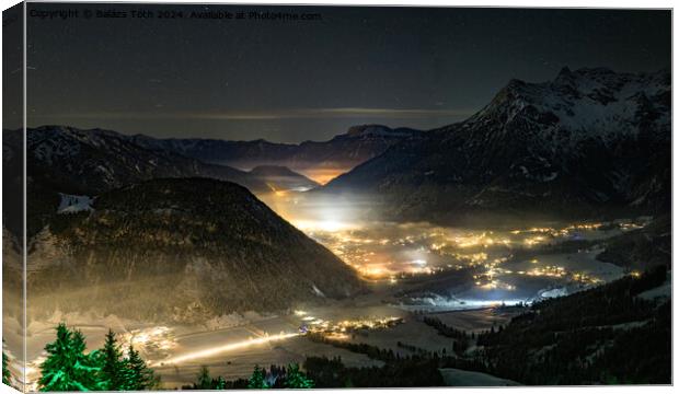 Village between the mountains at night Canvas Print by Balázs Tóth