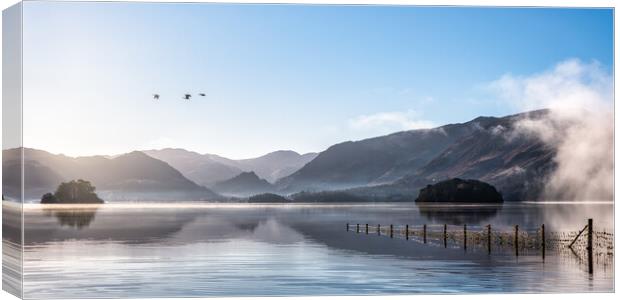 Derwent Water in Winter with geese flying over head Canvas Print by Julian Carnell