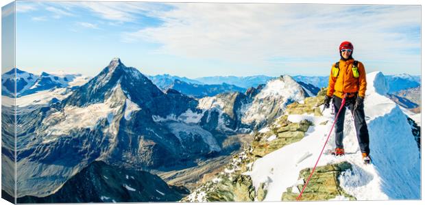 Alpine climber on the summit of Dent Blanche Canvas Print by Julian Carnell