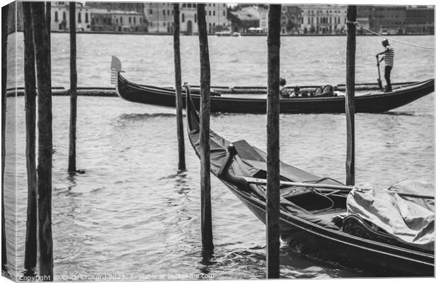 A gondolier or venetian boatman propelling a gondola on Grand Canal in Venice. Black and white photography. Canvas Print by Cristi Croitoru
