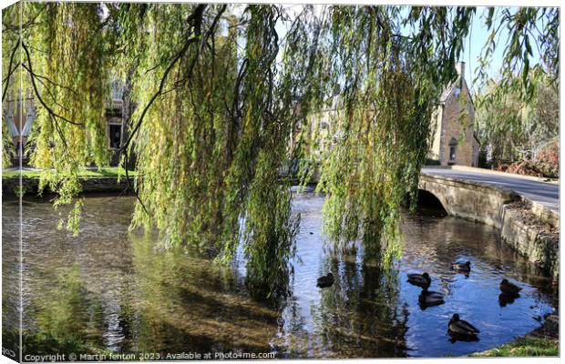 Willow trees in Bourton on the water Canvas Print by Martin fenton