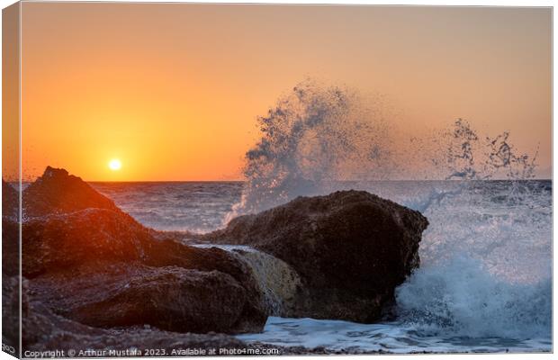 Sea waves crushing and splashing on the rocks in beautiful warm  Canvas Print by Arthur Mustafa
