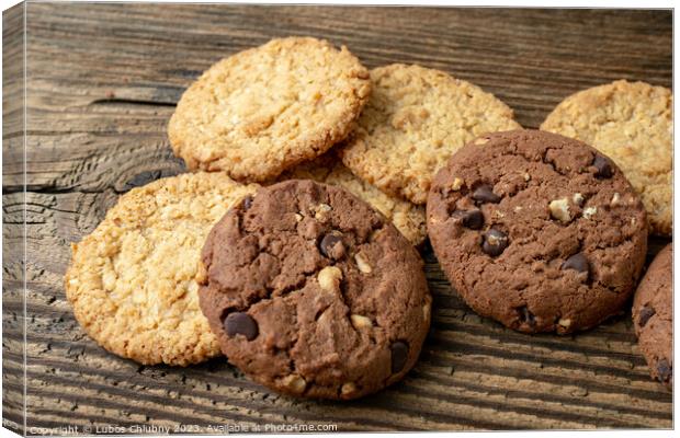 Various tasty cookies biscuits on wooden background Canvas Print by Lubos Chlubny