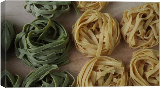 Fresh homemade egg pasta tagliatelle. Raw homemade pasta. Fettuccine pasta raw. Canvas Print by Irena Chlubna