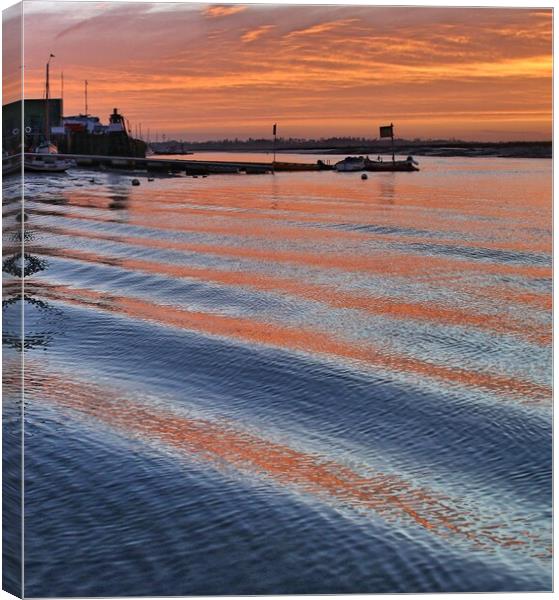 Sunrise reflections over er the passing wakes at Brightlingsea Harbour Canvas Print by Tony lopez