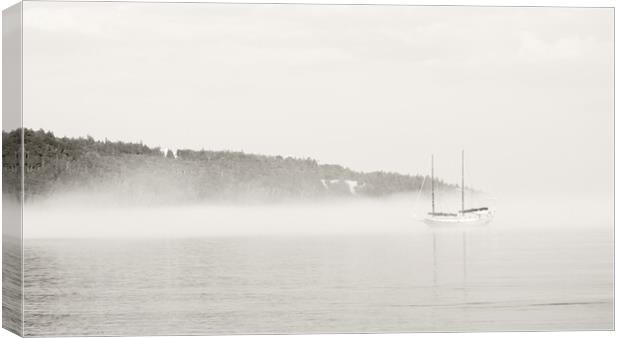 Misty Shore with Boat Canvas Print by Kevin Howchin