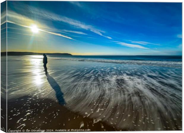 A Solo Walker on Woolacombe Beach. Canvas Print by Ian Donaldson