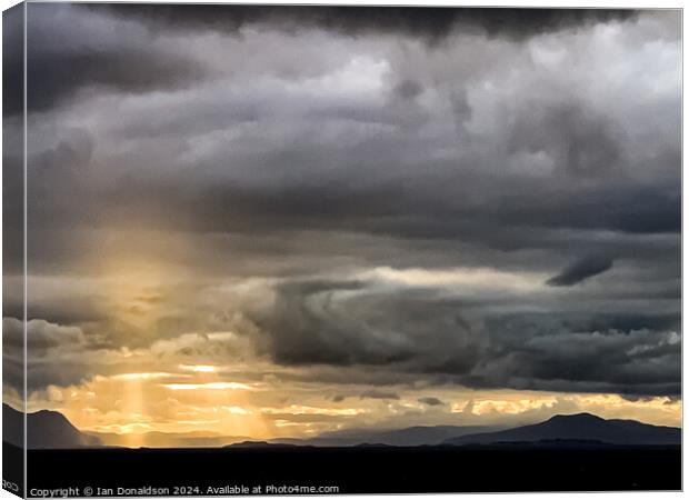 Sunlight Breaking Through a Stormy Scottish Sky Canvas Print by Ian Donaldson