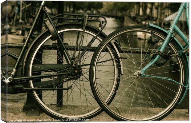 Close up of two bicycle wheels Canvas Print by Alan Collins