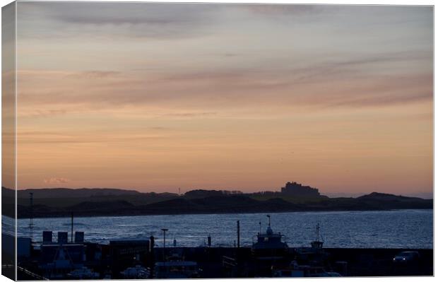 Sunset at Seahouses harbour bamburgh castle in the distance Canvas Print by Helen Reid