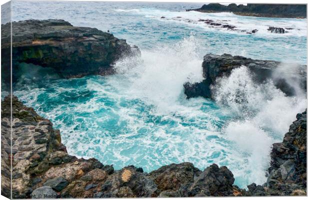 Large waves crash against the volcanic rock in La Palma Canvas Print by Madeleine Deaton