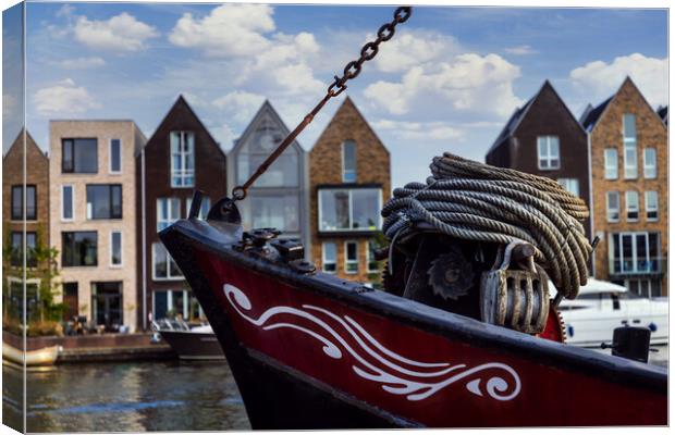 Boat on channel in Haarlem - Holland. Canvas Print by Olga Peddi