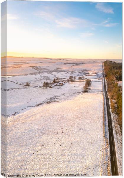 Long Snowy Road, Northumberland Canvas Print by Bradley Taylor