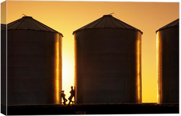father and son next to grain bins Canvas Print by Dave Reede